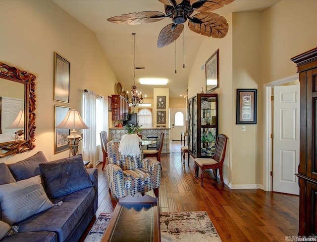 321 Peters Pt, Hot Springs, AR 71913 - living area with high vaulted ceiling, a chandelier, dark wood-type flooring, a ceiling fan, and baseboards