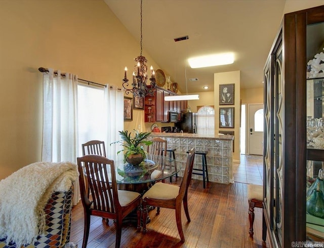 321 Peters Pt, Hot Springs, AR 71913 - dining space with a chandelier, vaulted ceiling, and dark wood-type flooring