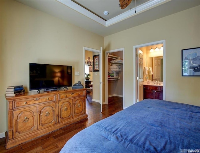 321 Peters Pt, Hot Springs, AR 71913 - bedroom featuring dark wood-style flooring, a walk in closet, connected bathroom, a sink, and a closet