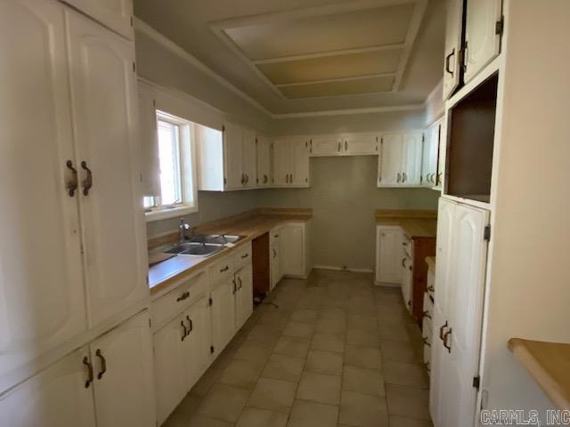 306 Edgar Ave, Mountain View, AR 72560 - kitchen with a sink, white cabinetry, and light tile patterned floors