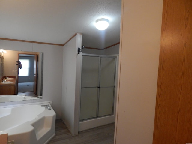 505 Main, West Point, AR 72178 - full bath featuring a stall shower, vanity, a bath, wood finished floors, and ornamental molding