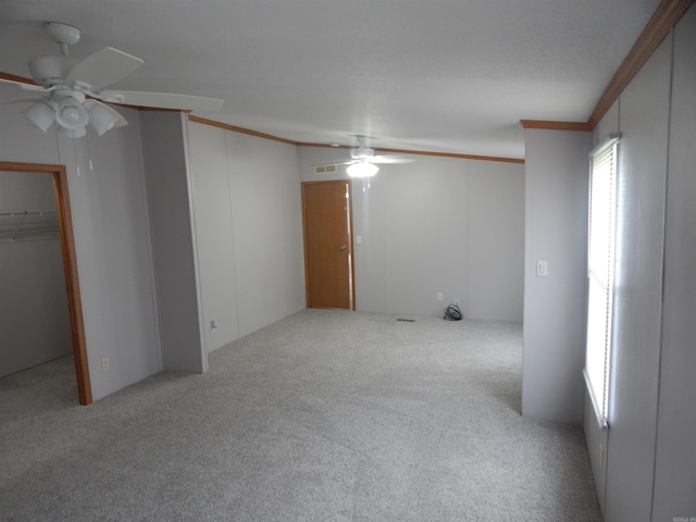 505 Main, West Point, AR 72178 - unfurnished bedroom featuring carpet flooring, crown molding, ceiling fan, and a spacious closet