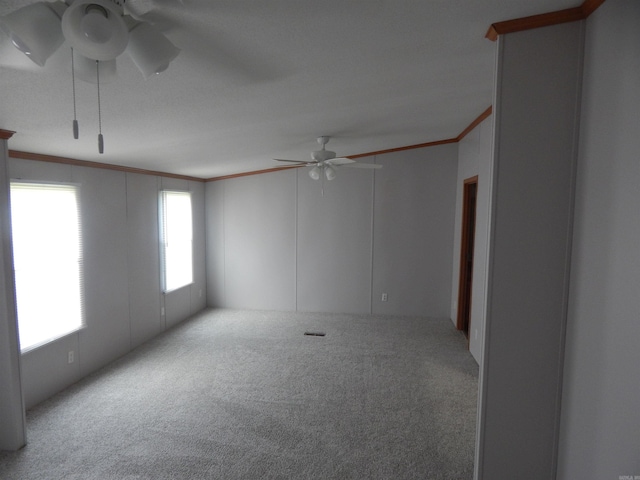 505 Main, West Point, AR 72178 - unfurnished room with a ceiling fan, ornamental molding, carpet floors, and a decorative wall