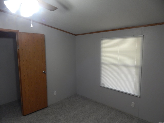505 Main, West Point, AR 72178 - empty room with a ceiling fan, carpet floors, lofted ceiling, and ornamental molding