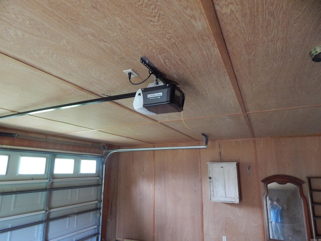 505 Main, West Point, AR 72178 - garage featuring a garage door opener, wooden walls, and electric panel