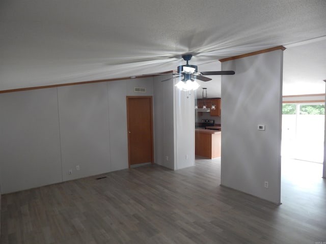 505 Main, West Point, AR 72178 - unfurnished room with a ceiling fan, wood finished floors, vaulted ceiling, a textured ceiling, and crown molding