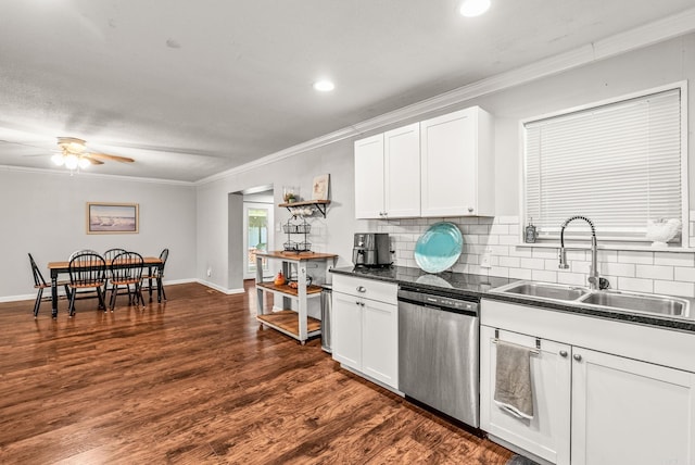 7110 Forest Dale Dr, North Little Rock, AR 72118 - kitchen with stainless steel dishwasher, a sink, dark countertops, crown molding, and decorative backsplash