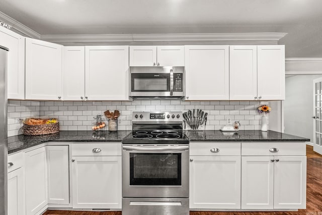 7110 Forest Dale Dr, North Little Rock, AR 72118 - kitchen featuring stainless steel appliances, white cabinetry, wood finished floors, dark stone countertops, and ornamental molding