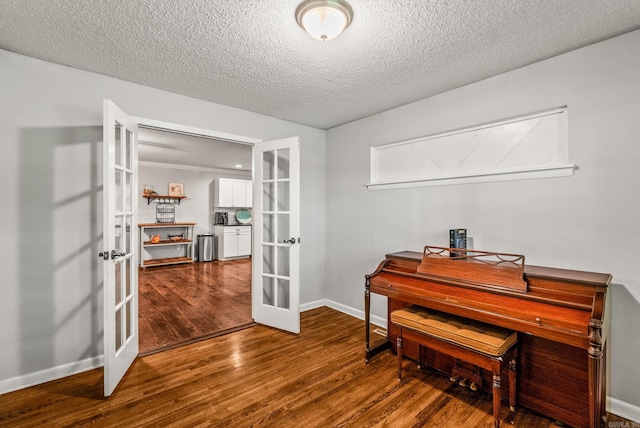 7110 Forest Dale Dr, North Little Rock, AR 72118 - office area with french doors, wood finished floors, a textured ceiling, and baseboards