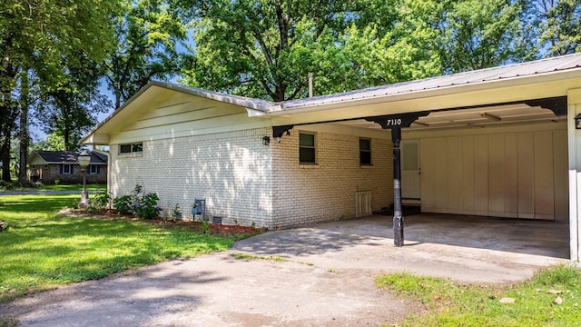 7110 Forest Dale Dr, North Little Rock, AR 72118 - view of side of property featuring a yard, driveway, brick siding, and metal roof