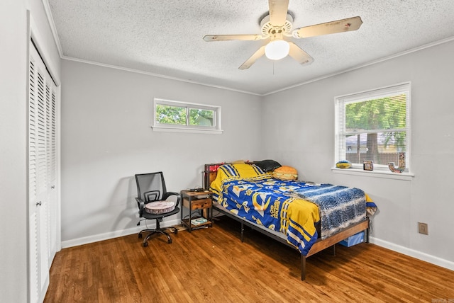 7110 Forest Dale Dr, North Little Rock, AR 72118 - bedroom featuring a closet, wood finished floors, a textured ceiling, baseboards, and ornamental molding