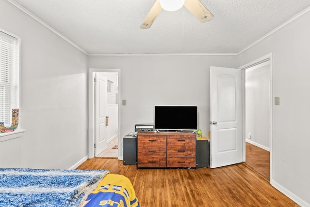 7110 Forest Dale Dr, North Little Rock, AR 72118 - bedroom with wood finished floors, ornamental molding, a textured ceiling, baseboards, and ensuite bathroom