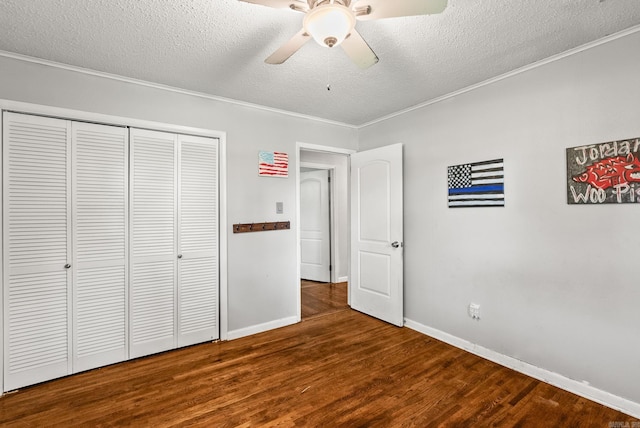 7110 Forest Dale Dr, North Little Rock, AR 72118 - unfurnished bedroom featuring wood finished floors, a textured ceiling, ornamental molding, baseboards, and a closet
