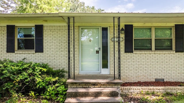 7110 Forest Dale Dr, North Little Rock, AR 72118 - view of exterior entry featuring brick siding, crawl space, and a porch