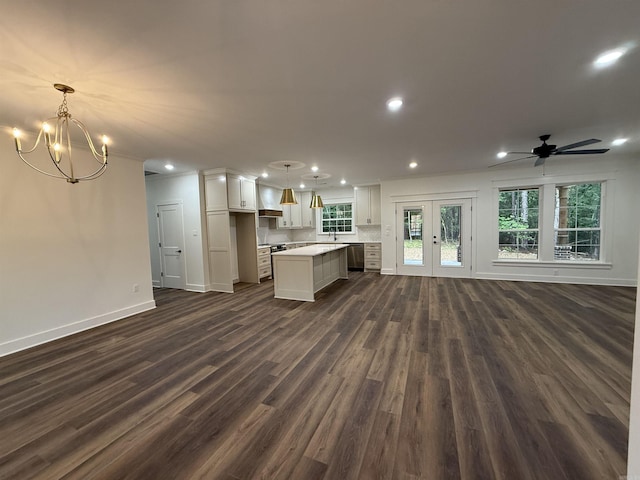 107 Elcano Dr, Hot Springs Village, AR 71909 - unfurnished living room featuring dark wood-style floors, recessed lighting, baseboards, a chandelier, and ceiling fan
