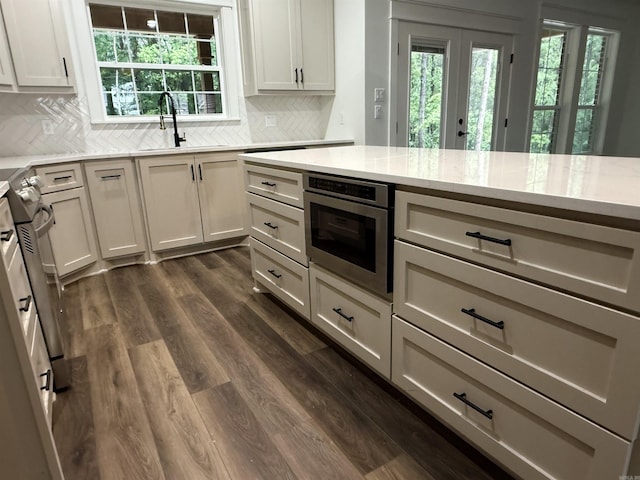 107 Elcano Dr, Hot Springs Village, AR 71909 - kitchen featuring a sink, dark wood-style flooring, backsplash, and light stone countertops