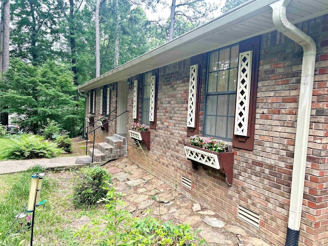 view of side of home with brick siding