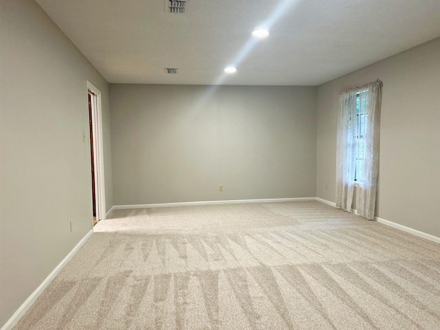 carpeted empty room featuring baseboards