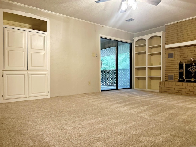 unfurnished living room with carpet, crown molding, ceiling fan, a fireplace, and a textured ceiling