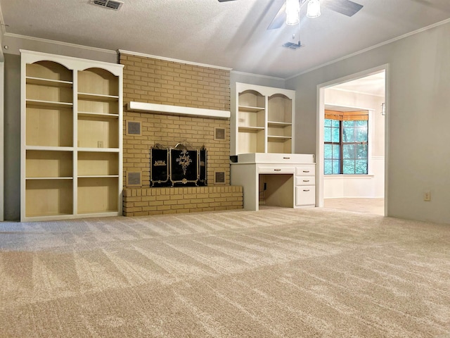 unfurnished living room with ornamental molding, carpet flooring, a ceiling fan, a fireplace, and built in shelves