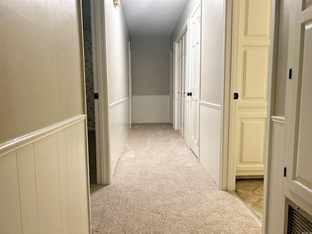 hallway with light carpet