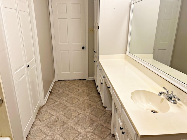 bathroom featuring vanity, tile patterned floors, and baseboards