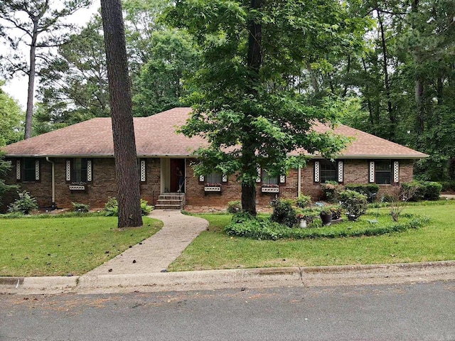 ranch-style home featuring a front lawn, brick siding, and a shingled roof