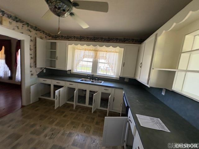 405 3rd Ave, Murfreesboro, AR 71958 - kitchen with open shelves, dark countertops, a sink, dark wood finished floors, and white cabinets