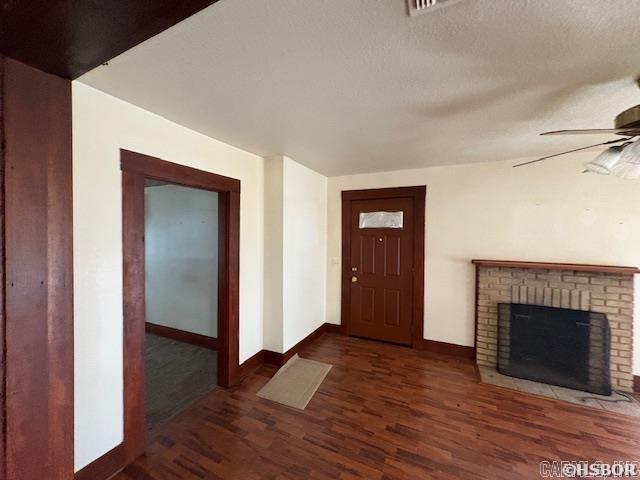 405 3rd Ave, Murfreesboro, AR 71958 - entrance foyer featuring baseboards, wood finished floors, a ceiling fan, and a brick fireplace