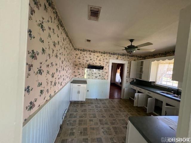 405 3rd Ave, Murfreesboro, AR 71958 - kitchen with wallpapered walls, a ceiling fan, dark countertops, a sink, and dark floors