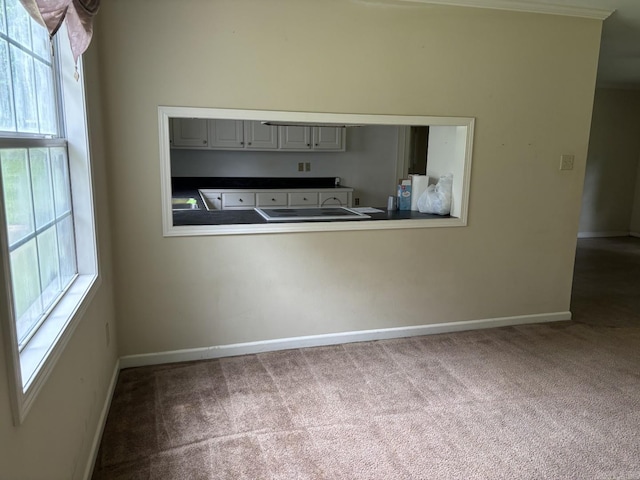 1006 Austin St, Camden, AR 71701 - kitchen featuring carpet flooring, baseboards, dark countertops, and gray cabinets