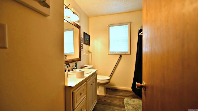 514 Proft Cir, Mena, AR 71953 - full bathroom with toilet, vanity, wood finished floors, baseboards, and a shower with shower curtain