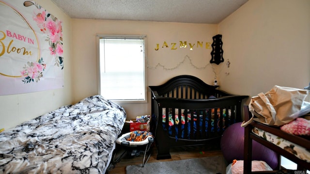 514 Proft Cir, Mena, AR 71953 - bedroom featuring wood finished floors and a textured ceiling