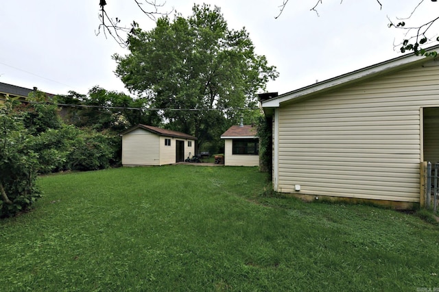 514 Proft Cir, Mena, AR 71953 - view of green lawn with an outbuilding