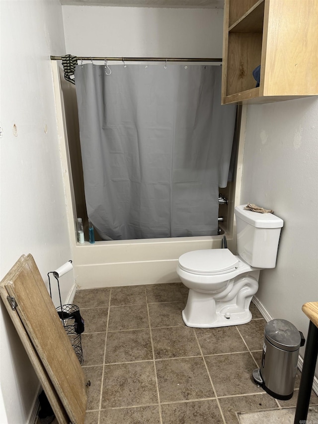 bathroom featuring shower / tub combo, toilet, baseboards, and tile patterned flooring