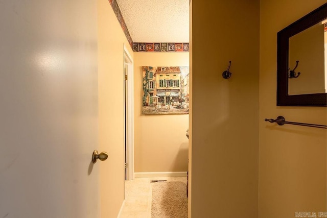 135 Hillview # 38, Fairfield Bay, AR 72088 - hallway featuring a textured ceiling, tile patterned floors, and baseboards