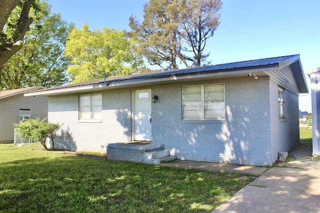 312 S Crossroads, Portia, AR 72457 - back of property featuring brick siding, a lawn, and metal roof