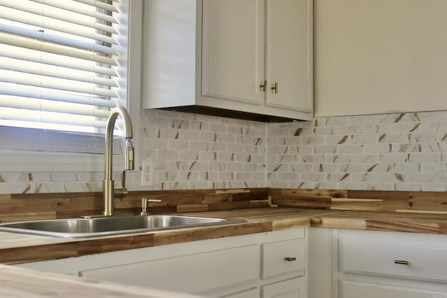 312 S Crossroads, Portia, AR 72457 - kitchen with butcher block counters, a sink, backsplash, and white cabinets
