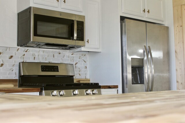 312 S Crossroads, Portia, AR 72457 - kitchen view of stainless steel appliances, tasteful backsplash, white cabinets, and light countertops