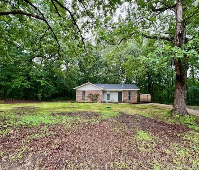 707 Maple, Forrest City, AR 72335 - single story home with brick siding, a front lawn, and a wooded view