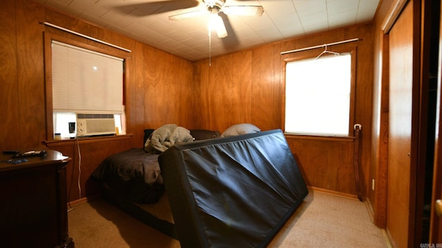 911 Gillham, Mena, AR 71953 - bedroom featuring light carpet, wood walls, cooling unit, and a ceiling fan