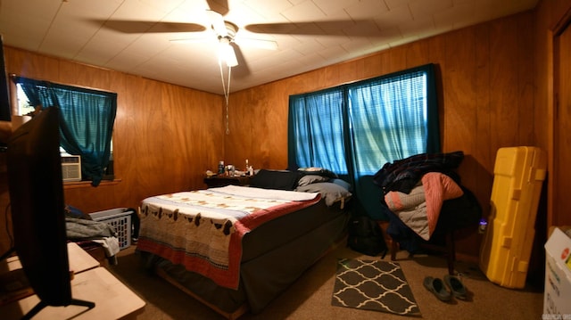 911 Gillham, Mena, AR 71953 - bedroom with wood walls, carpet floors, and a ceiling fan