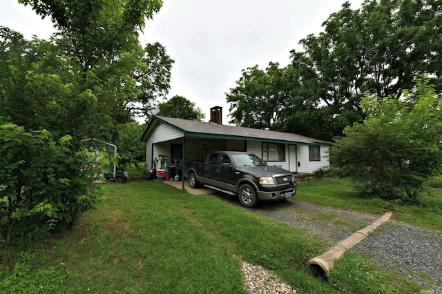 911 Gillham, Mena, AR 71953 - ranch-style home featuring a front lawn, a chimney, and driveway