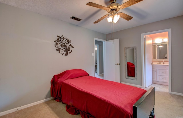 2931 Salem Rd, Benton, AR 72019 - bedroom featuring light colored carpet, baseboards, connected bathroom, a ceiling fan, and a sink