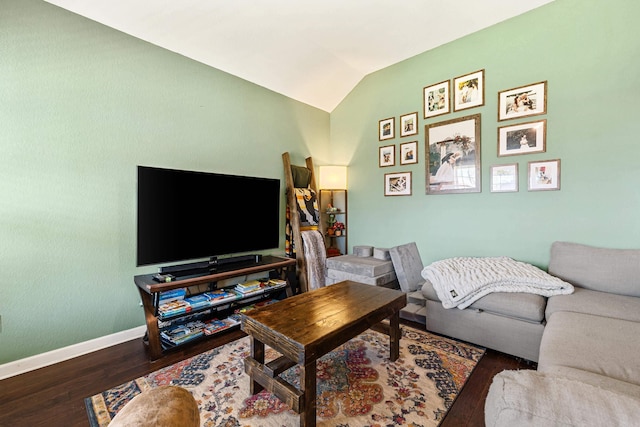 living room featuring wood finished floors, vaulted ceiling, and baseboards