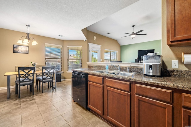 kitchen with a sink, dishwasher, dark countertops, plenty of natural light, and lofted ceiling