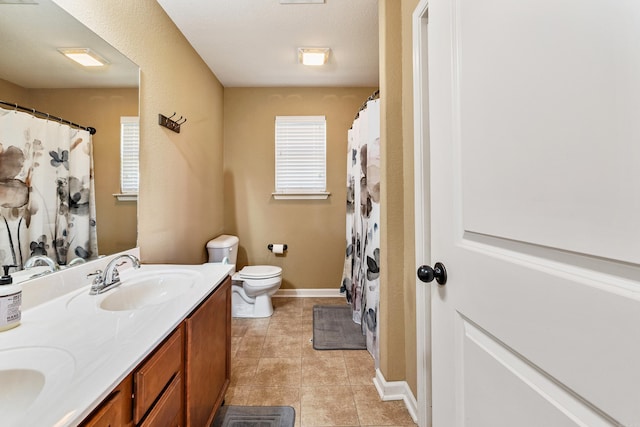 bathroom featuring double vanity, toilet, tile patterned flooring, baseboards, and a shower with shower curtain
