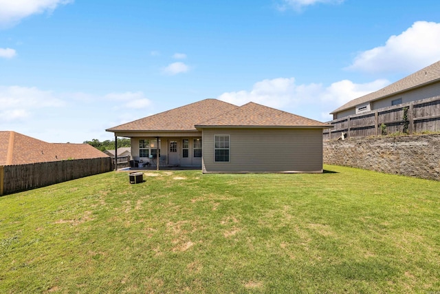 rear view of property featuring an outdoor fire pit and roof with shingles