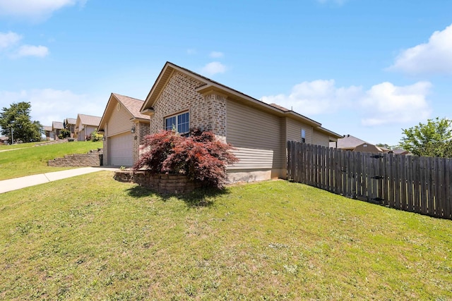 view of home's exterior featuring an attached garage, concrete driveway, and brick siding