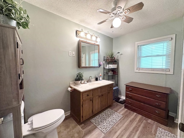 300 Michelle Ave, White Hall, AR 71602 - bathroom featuring a ceiling fan, toilet, vanity, a textured ceiling, and wood finished floors